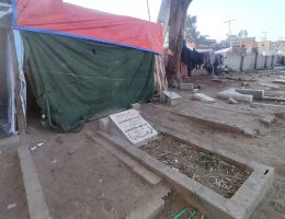 The Allouh family tents right up against the gravestones in Deir Al-Balah's Ansar cemetery.
