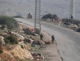 Israeli soldiers block an empty road in the northern West Bank