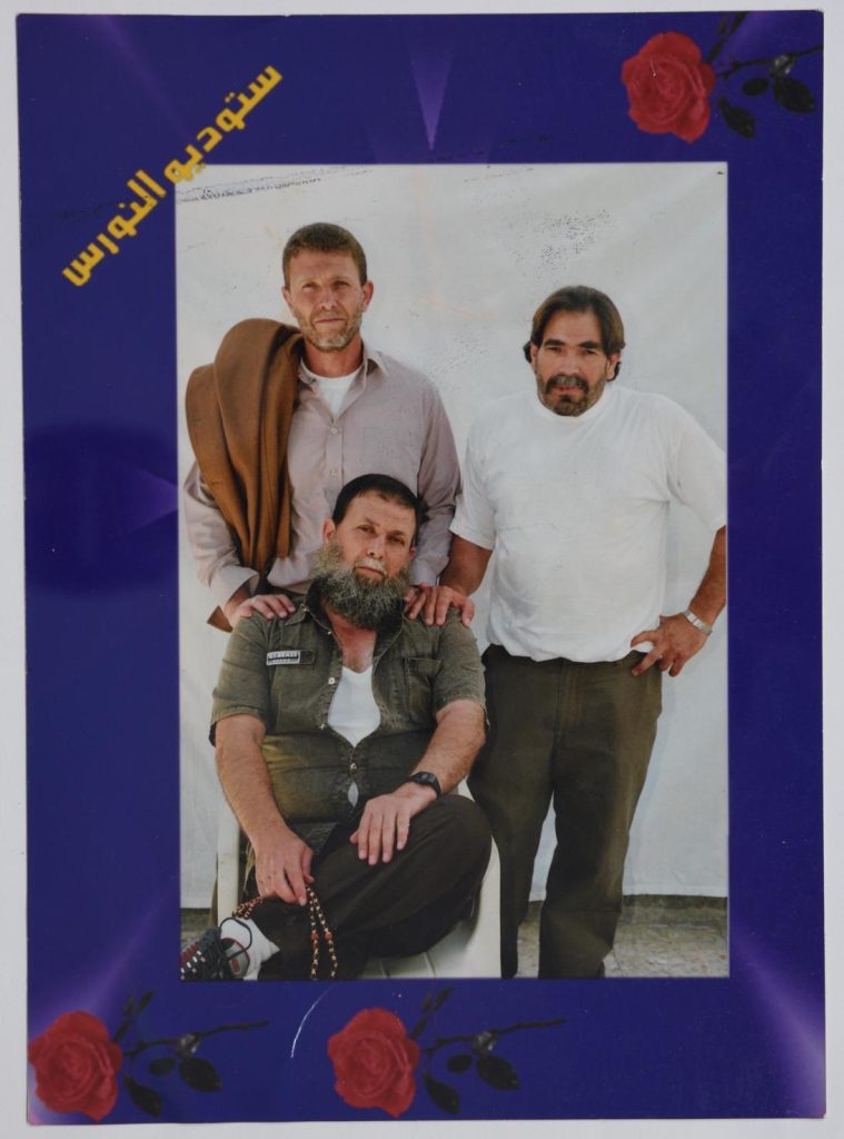 Nael Barghouthi (left), his brother Omar Barghouthi (seated), and his cousin Fakhri Barghouthi (right) in Askalan Prison, 2004. (Photo courtesy of author)