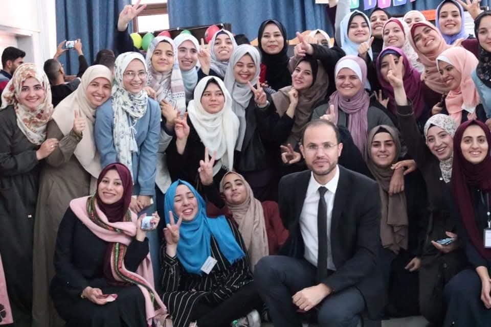 Dr. Refaat Alareer, lower right, with his students at a poetry fair he organized at the Islamic University of Gaza, IUG in 2019. (Photo courtesy of Reem Hamadaqa)