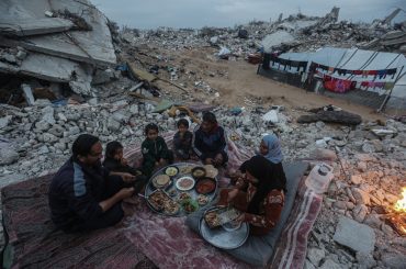 Palestinian Karam Abu Haloub and his wife Faten prepare iftar food during the third day of the holy month of Ramadan in a tent they set up on the ruins of their destroyed home in the Al-Shimaa area of Beit Lahia in the northern Gaza Strip, March 3, 2025. Thousands of Palestinian families in the Gaza Strip live in tents amidst a lack of basic necessities after the Israeli war on the Gaza Strip. (Photo by Omar Ashtawy/ apaimages)