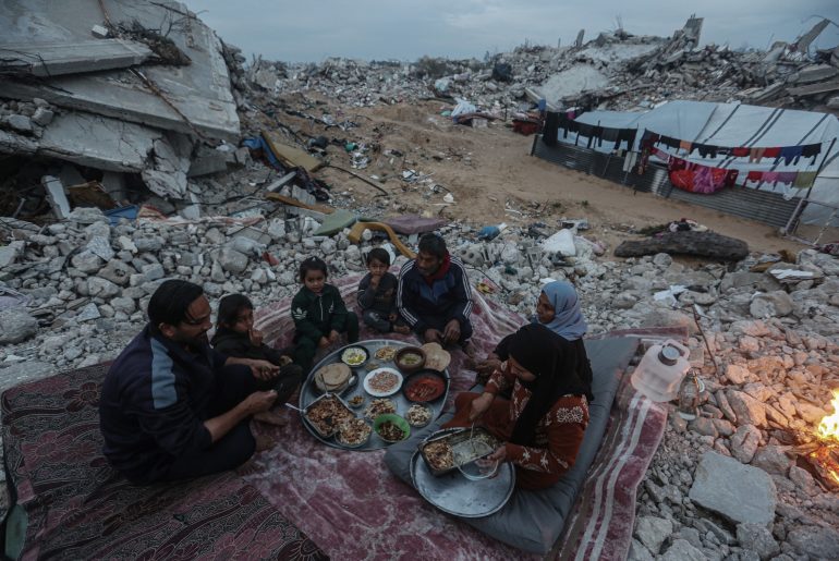 Palestinian Karam Abu Haloub and his wife Faten prepare iftar food during the third day of the holy month of Ramadan in a tent they set up on the ruins of their destroyed home in the Al-Shimaa area of Beit Lahia in the northern Gaza Strip, March 3, 2025. Thousands of Palestinian families in the Gaza Strip live in tents amidst a lack of basic necessities after the Israeli war on the Gaza Strip. (Photo by Omar Ashtawy/ apaimages)