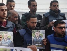 Palestinian journalists lift placards during a rally in protest of the killing of fellow reporters Hussam Shabat and Muhammad Mansour in Israeli strikes a day earlier, in Gaza City on March 25, 2025. (Photo: Omar Ashtawy/APA Images)