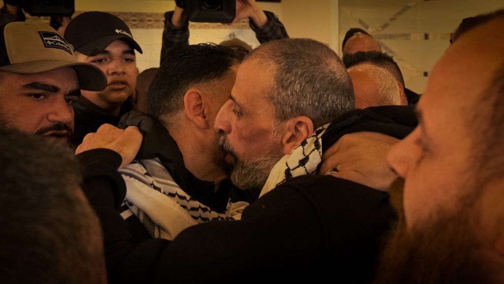 Amir Abu Raddaha greeted by relatives upon arriving at Ramallah’s Cultural Palace following his release from Israeli prison as part of a ceasefire prisoner swap between Israel and Hamas, February 15, 2025. (Photo: Qassam Muaddi/Mondoweiss)