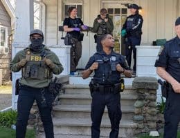 FBI agents and police outside a home in Michigan (Photo via Instagram)