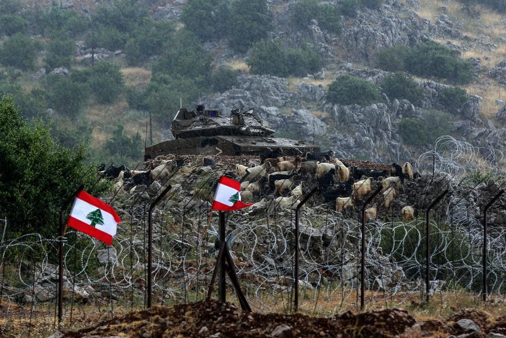 Cattle move near an Israel tank positioned on the southern Lebanese border near Kfarchouba and Shebaa Farms during clashes with Lebanese citizens. Lebanese protesters removed barbed wire and hurled stones at Israeli forces, who fired tear gas in return, June 9, 2023. (Photo: Marwan Naamani/dpa via ZUMA Press/APA Images)