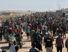 Palestinians seeking aid gather near an aid distribution site run by the U.S.-backed Gaza Humanitarian Foundation, Rafah, May 27, 2025. (Photo: Abdullah Abu Al-Khair/APA Images)