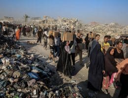 Palestinians carry food parcels distributed by Gaza Humanitarian Foundation, June 16, 2025. (Photo: Omar Ashtawy/APA Images)