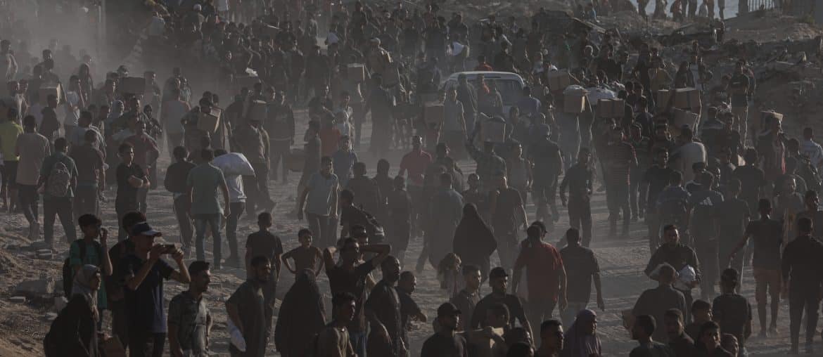 Palestinians carry food parcels distributed by Gaza Humanitarian Foundation, June 16, 2025. (Photo: Omar Ashtawy/APA Images)