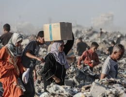 Palestinians carry food parcels distributed by the Gaza Humanitarian Foundation. Palestinians in Gaza are being routinely killed while attempting to retrieve aid from GHF-run 'aid distribution' sites. (Photo by Omar Ashtawy/apaimages)