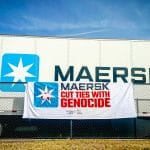 A banner from the "Mask off Maersk" campaign in front of a Maersk container. (Photo: Palestinian Youth Movement)