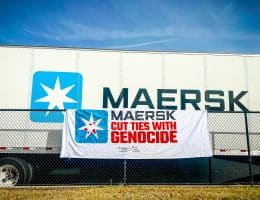 A banner from the "Mask off Maersk" campaign in front of a Maersk container. (Photo: Palestinian Youth Movement)