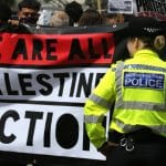 Protesters hold a banner in support of Palestine Action outside Parliament following Home Secretary Yvette Cooper's announcement that she planned to initiate the proscription of the organization, on June 25, 2025. (Photo: Novapix)