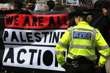 Protesters hold a banner in support of Palestine Action outside Parliament following Home Secretary Yvette Cooper's announcement that she planned to initiate the proscription of the organization, on June 25, 2025. (Photo: Novapix)