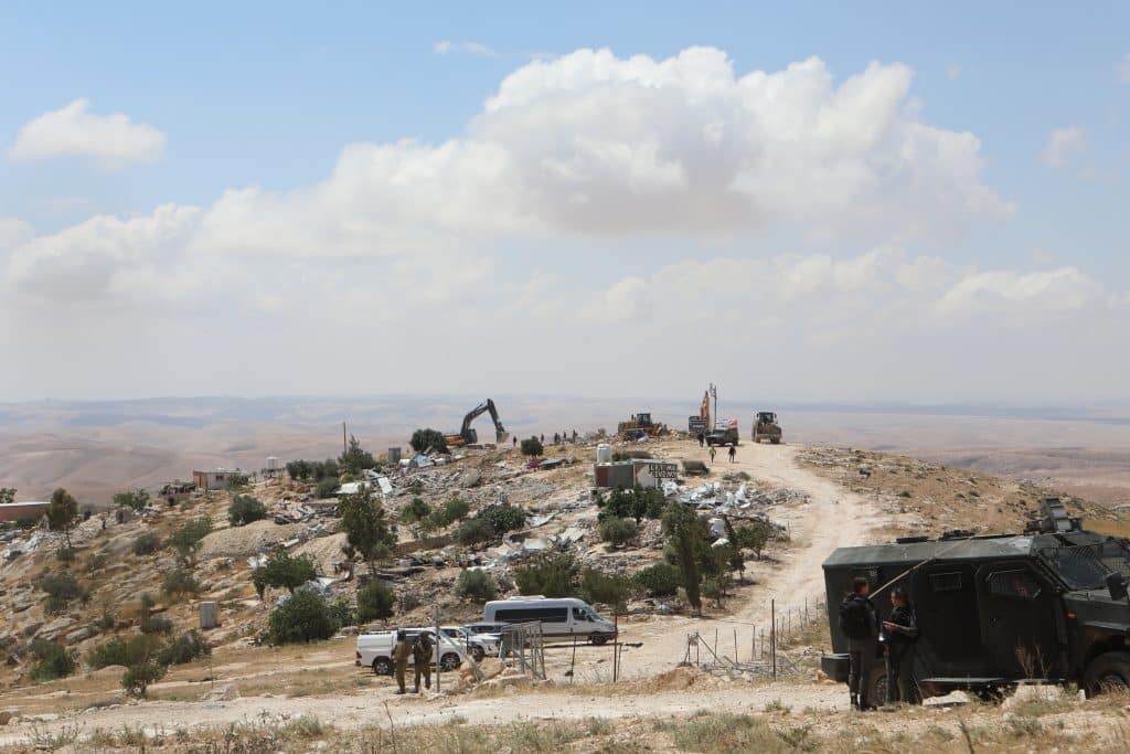 Israeli forces demolish Palestinian structures in the village of Khallet al-Dabe' in Masafer Yatta in the South Hebron Hills, May 5, 2025. (Photo: Mamoun Wazwaz/APA Images)