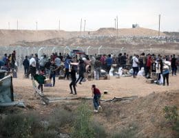 Palestinians in cages gathering aid from the U.S.-backed Gaza Humanitarian Foundation in Al-Bureij, central Gaza, June 8, 2025. (Photo: Moiz Salhi/APA Images)