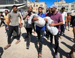 Palestinians carry the bodies of relatives who were killed in Israeli strikes targeting a water filling station, at the Al-Awda hospital, in Nuseirat refugee camp, central Gaza Strip, on July 13, 2025. (Photo by Belal Abu Amer /apaimages)