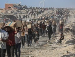 Palestinians carry food parcels distributed by Gaza Humanitarian Foundation, June 16, 2025. (Photo: Omar Ashtawy/APA Images)