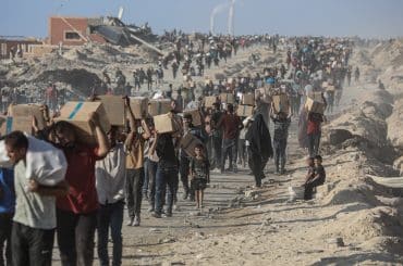 Palestinians carry food parcels distributed by Gaza Humanitarian Foundation, June 16, 2025. (Photo: Omar Ashtawy/APA Images)