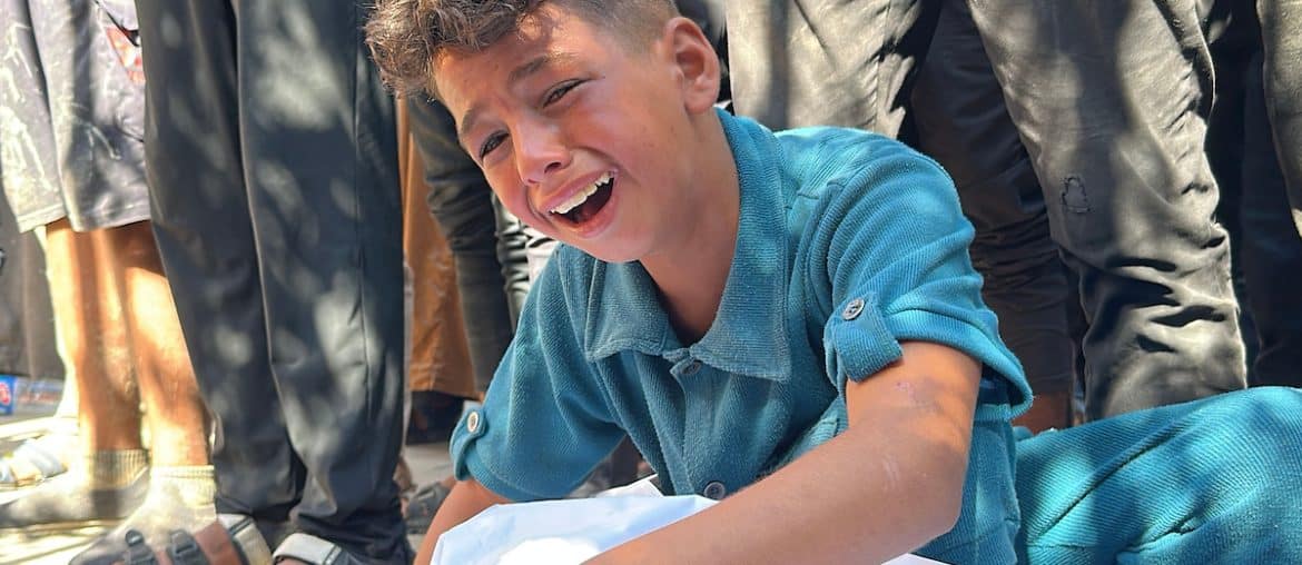 A Palestinian child mourns a loved one killed on Wednesday while seeking aid in Khan Younis, at Nasser hospital in the southern Gaza Strip on July 16, 2025. (Photo: Moaz Abu Taha/APA Images)