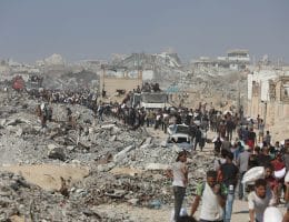 Palestinians carry aid supplies through a decimated Beit Lahia in the northern Gaza Strip, on August 2, 2025. (Photo: Omar Ashtawy/APA Images)