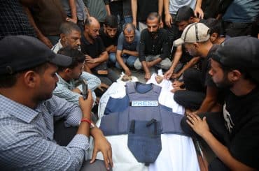 Palestinians mourn over the body of Al Jazeera correspondent Anas al-Sharif, who was killed alongside other journalists in an overnight Israeli strike on their tent in Gaza City, August 11, 2025. (Photo: Omar Ashtawy/APA Images)
