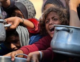 Palestinians wait to receive food from a charity kitchen amid a hunger crisis in Khan Younis, August 21, 2025. (Photo by Mohammed Salama/apaimages)