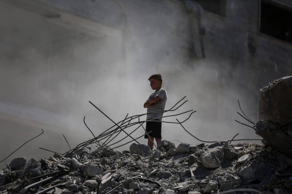 Palestinians walk through the rubble of the Tiba tower which crashed to the ground moments after Israeli strikes targeted the high-rise building in Gaza City on September 10, 2025. Israel's military said on September 9, it will act with "great force" in Gaza City and told residents to leave as it stepped up a deadly assault on the Palestinian territory's largest urban centre. (Photo: Omar Ashtawy/APA Images)