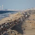 Displaced Palestinians march north along the coastal road between the central Gaza Strip and Gaza City during the ceasefire between Israel and Hamas, October 10, 2025. (Photo: Omar Ashtawy/APA Images)