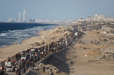 Displaced Palestinians march north along the coastal road between the central Gaza Strip and Gaza City during the ceasefire between Israel and Hamas, October 10, 2025. (Photo: Omar Ashtawy/APA Images)