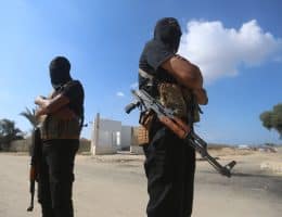 Members of the armed wing of Hamas, the al-Qassam Brigades, stand guard during the handover of Israeli captives to the Red Cross as part of the first phase of the ceasefire between Israel and Hamas, October 13, 2025. (Photo: Omar Ashtawy/APA Images)