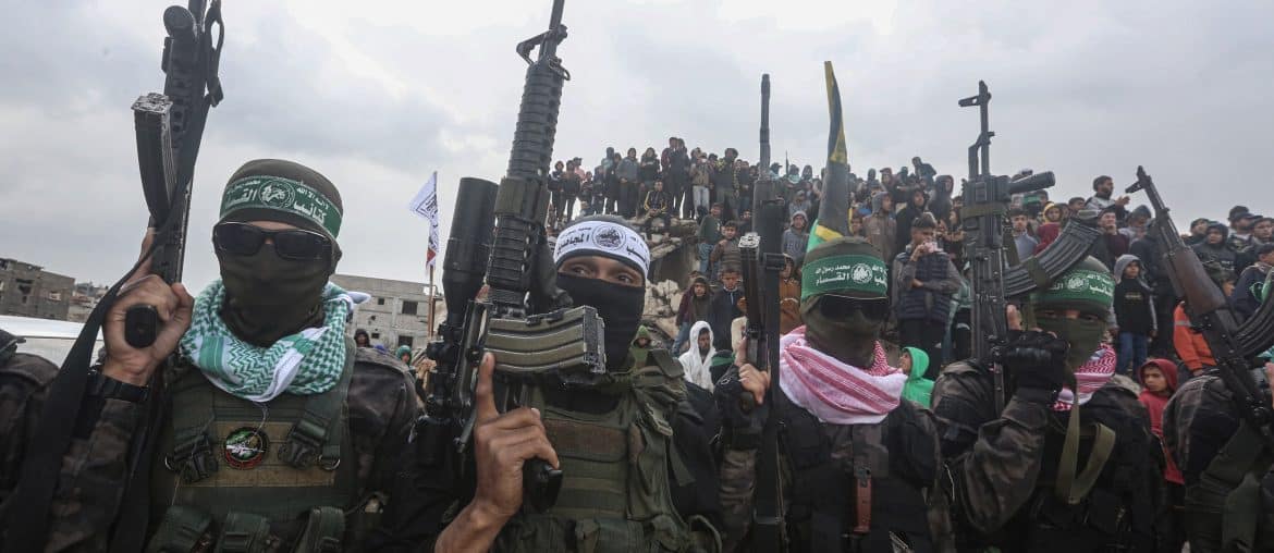 Members of the Qassam Brigades, the military wing of Hamas, during the handover of the bodies of the Bibas family and Oded Lifshitz to the Red Cross, February 20, 2025. (Photo: Omar Ashtawy/APA Images)