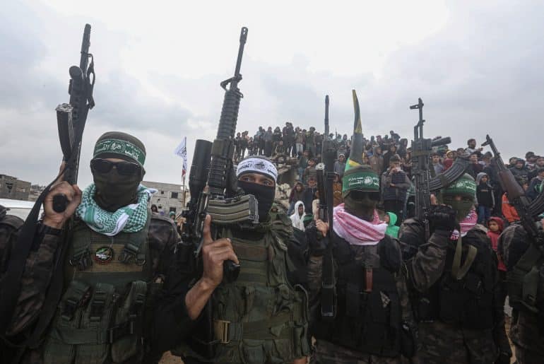 Members of the Qassam Brigades, the military wing of Hamas, during the handover of the bodies of the Bibas family and Oded Lifshitz to the Red Cross, February 20, 2025. (Photo: Omar Ashtawy/APA Images)