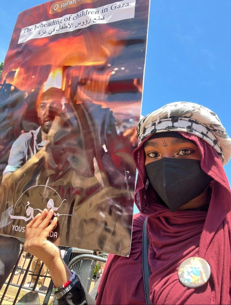 Khan with a picket sign during a Dallas protest. (Photo : Afsheen Khan)