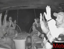 Activists onboard the Meteque, a ship that took part in the Global Sumud Flotilla, sit with their hands up on the deck as Israeli military forces illegally commandeer the boat in international waters. (Screengrab via Global Sumud Flotilla)