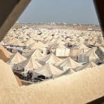 Palestinians whose homes were destroyed in Israeli attacks are struggling to survive in makeshift tents built over the rubble in the El Mugraka area in central Gaza on November 9, 2025. Despite the lack of basic necessities, residents continue to endure harsh living conditions as they fight to stay warm and find shelter amid the devastation left by the war. (Photo by Belal Abu Amer / APA Images)