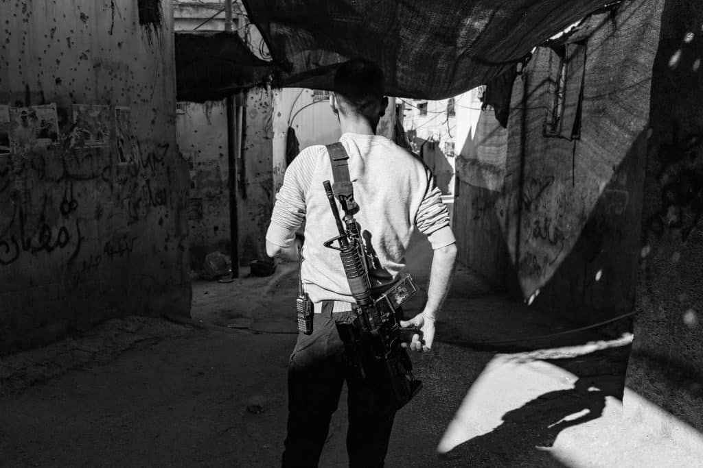 A commander of one of Jenin's resistance groups poses for a portrait at the camp. He preferred to keep his identity hidden for security reasons. (Photo: David Lombeida)
