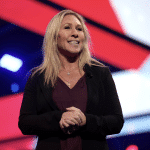 Wikimedia ( U.S. Congresswoman Marjorie Taylor Greene speaking with attendees at the 2021 AmericaFest at the Phoenix Convention Center in Phoenix, Arizona)