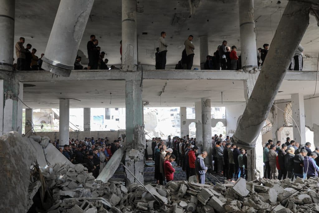 Palestinians perform Friday prayer amid the rubble of Salah Al-Din Mosque, which was destroyed in Israeli attacks, in el-Zeytun neighborhood in southern Gaza City, Gaza, on December 05, 2025. (Photo: Omar Ashtawy/APA Images)