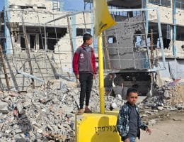 Displaced Palestinian families sheltering inside the UNRWA-run Malak School in Bani Suheila, east of Khan Younis, find themselves suddenly located within the newly designated "yellow line" after the Israeli army repositioned the yellow concrete blocks used to demarcate the so-called "temporary withdrawal line" inside Gaza, December 9, 2025. (Photo: Tariq Mohammad/APA Images)