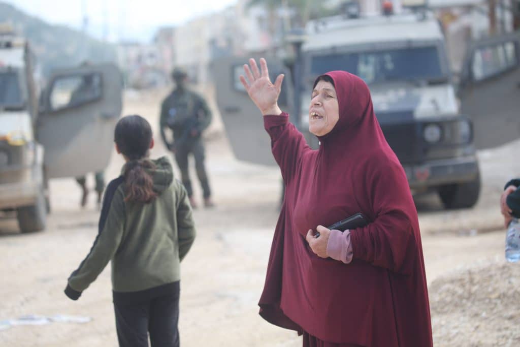 Palestinian residents of Nur Shams refugee camp and foreign activists gather at the camp's entrance during a protest demanding their right to return to their homes, December 15, 2025. (Photo: Mohammed Nasser/APA Images)