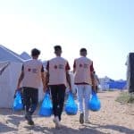 American Friends Service Committee staff distributing food parcels in Gaza. (Photo: Amjad Al Fayoumi/AFSC)