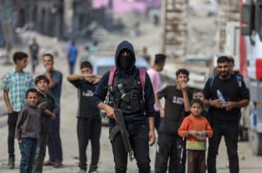Al-Qassam Brigade team members oversee rubble removal in search of bodies of deceased Israeli captives, Baghdad Street, Shuja'iyya, November 3, 2025. (Photo: Omar Ashtawy/APA Images)