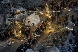 Palestinians gather between destroyed houses to break their fast together during the holy month of Ramadan in the northern Gaza Strip, February 22, 2026. (Photo: Omar Ashtawy/APA Images)