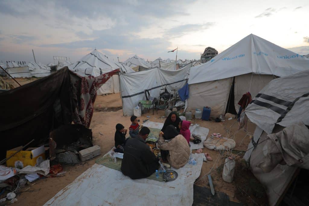 A Palestinian family prepares to break their fast outside their tent in a camp in the central Gaza Strip during Ramadan. (Photo: Stringer/APA Images)