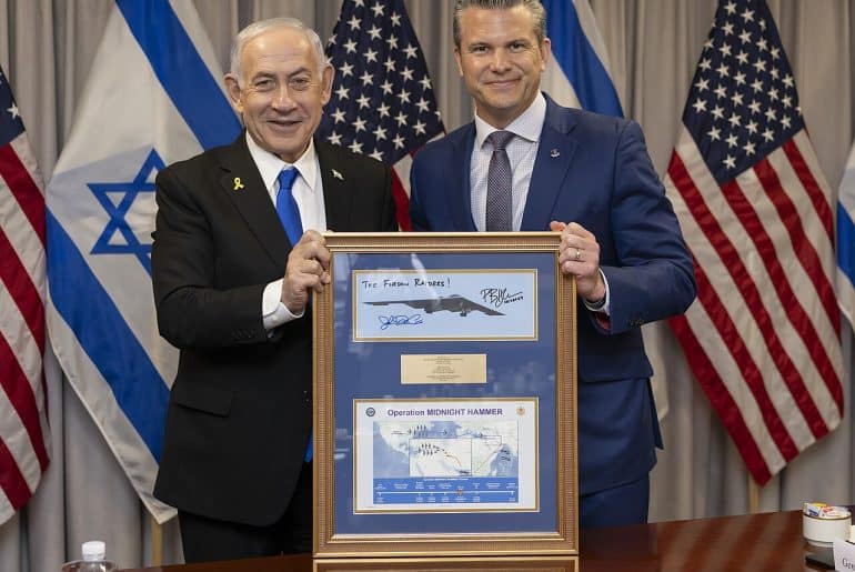 Secretary of Defense Pete Hegseth presents a framed photo of a B-2 Spirit stealth bomber and a map of Operation Midnight Hammer, launched against Iran on June 22, 2025, to Israeli Prime Minister Benjamin Netanyahu at the Pentagon in Washington, D.C., July 9, 2025. (DoD photo by U.S. Navy Petty Officer 1st Class Alexander Kubitza)