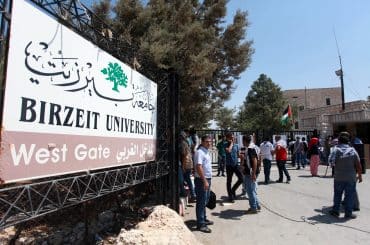 Students gather in front of the closed entrance of Birzeit University during a strike protesting rising tuition fees, September 2, 2013. (Photo: Issam Rimawi/APA Images)