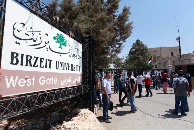 Students gather in front of the closed entrance of Birzeit University during a strike protesting rising tuition fees, September 2, 2013. (Photo: Issam Rimawi/APA Images)