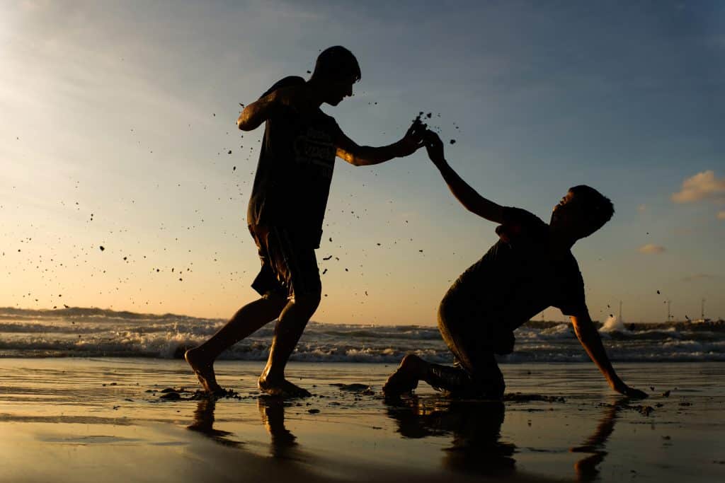 Two boys play in the shallow water along Gaza’s shoreline during the late afternoon, July 11, 2022. (Photo: Mahmoud Nasser)