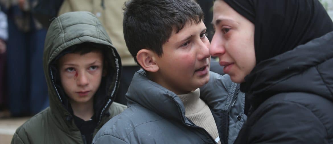 Mustafa Bani Odeh (left), his older brother Khaled, (center), at the funeral of their family of two parents and two other siblings who were killed by Israeli special forces when they were driving back to their hometown of Tammoun in the northern West Bank, March 15, 2026. (Photo: Mohammed Nasser/APA Images)